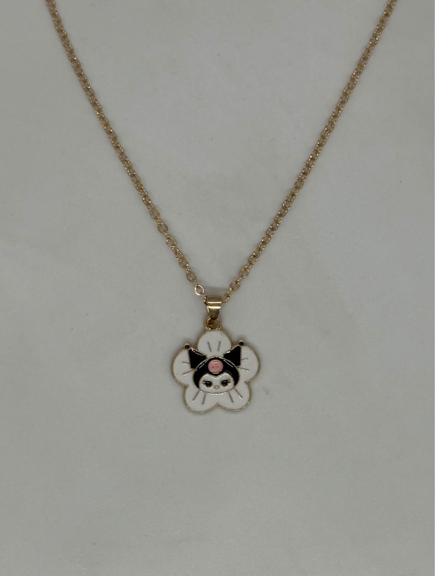 Sanrio Kuromi stainless steel necklace featuring an enamel-plated pendant of the character on a golden chain