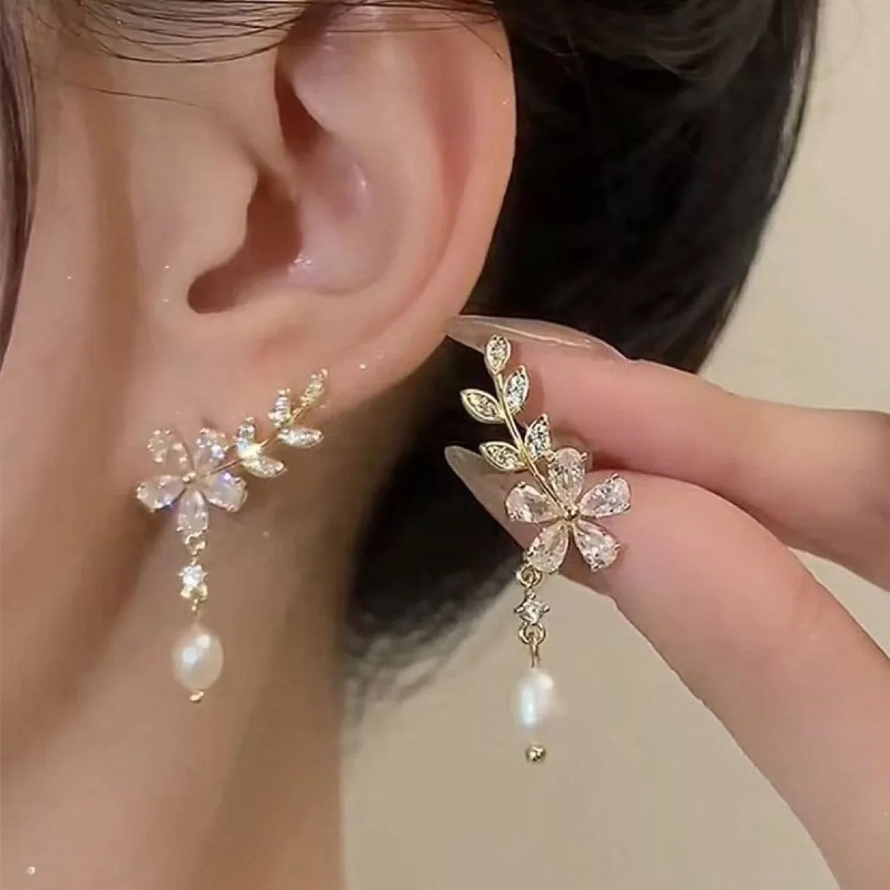 Stylish pearl earrings featuring a flower and leaf design, with waterproof zirconia studs